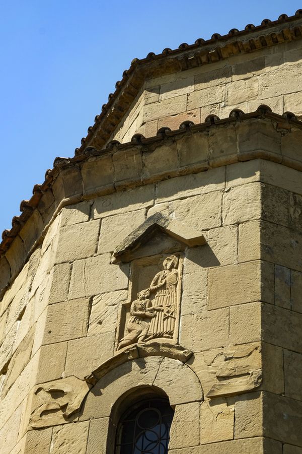 Stone relief above the entrance — two angels holding a cross