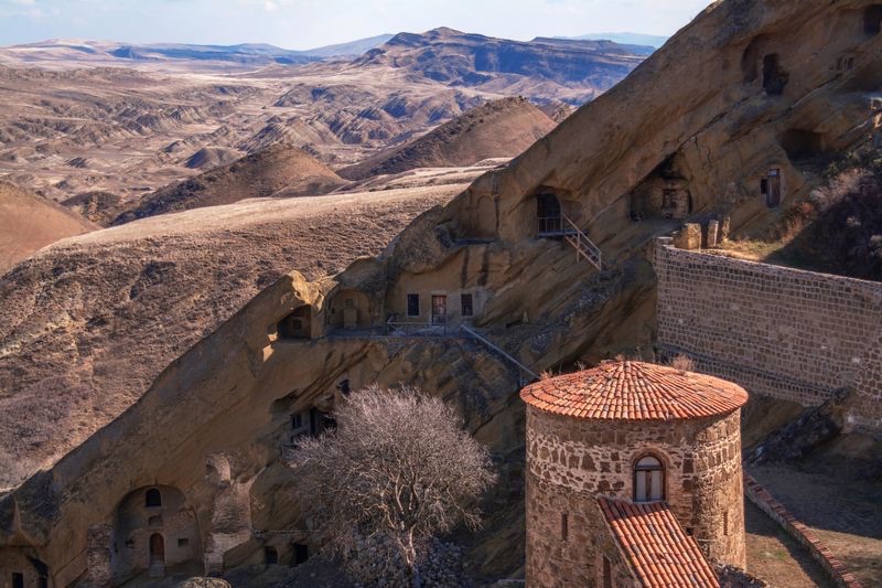 Rock-cut monastery cells of David Gareja against the sandstone cliff