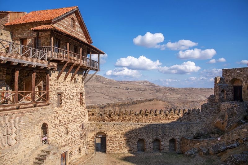 Monastery courtyard with wooden balconies and stone buildings