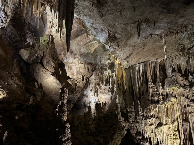 Wide chamber with long hanging stalactites in Prometheus Cave