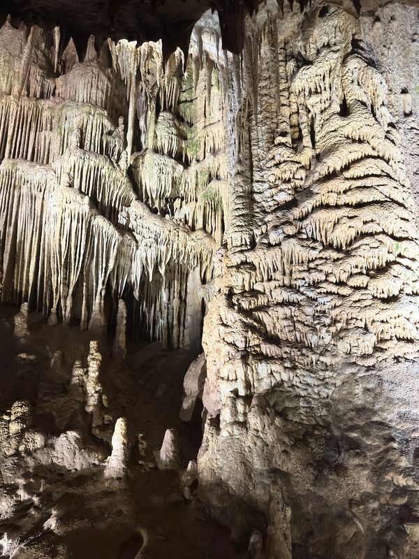 Dense wall of stalactites and stalagmites in Prometheus Cave