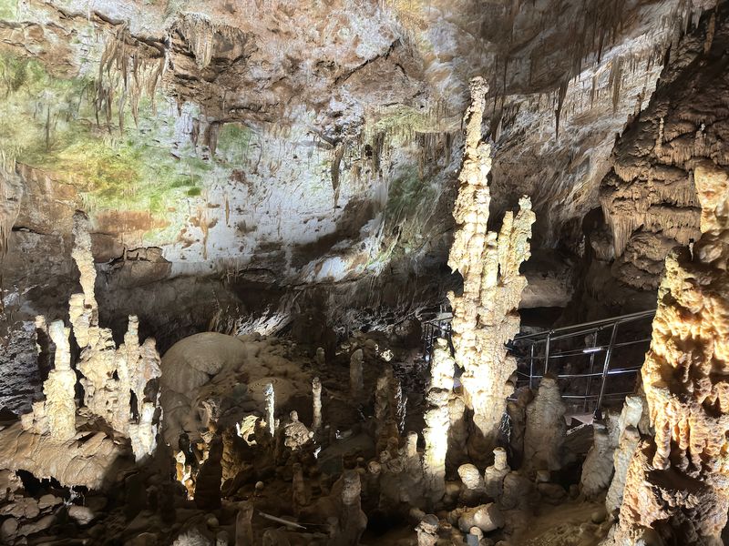 Forest of stalagmites with a tourist walkway in Prometheus Cave